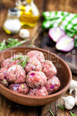 Raw meatballs close-up on wooden background