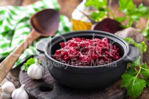 Beetroot salad on wooden background closeup