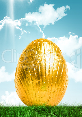 Gold Easter egg in front of blue sky