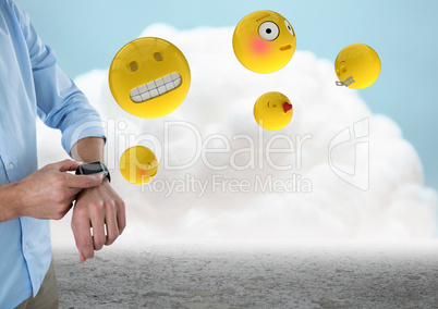 Business man mid section with watch and emojis against cloud and ground