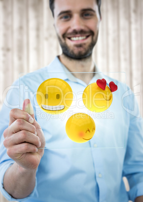 Business man with glass device and emoji with flare against blurry wood panel