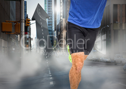 Male runner legs on arrow shaped road in street