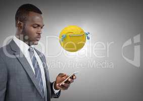 Business man on phone with emoji and flare against grey background