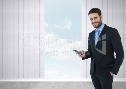 Businessman with phone and opening to sky
