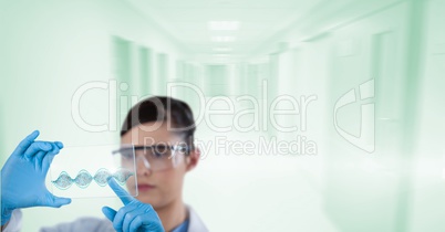 Doctor ( woman) at the hall of the hospital using futuristic tactile screen