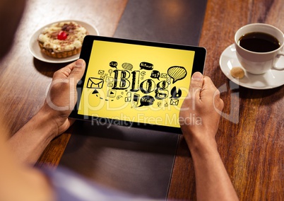 Hands with tablet showing black blog doodles against yellow background