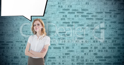 Portrait of confident businesswoman standing arms crossed with speech bubble against brick wall