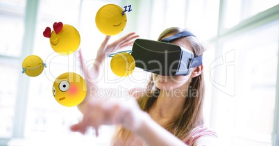 Woman in  VR glasses touching various emojis