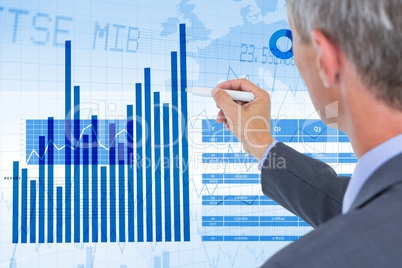 Businessman analyzing graph on screen