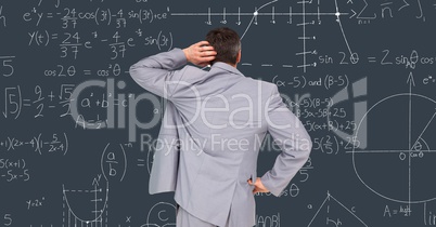 Confused businessman reading math equations