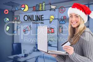 Woman wearing Santa hat while shopping online