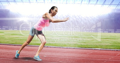 Full length of female athlete running on racing track