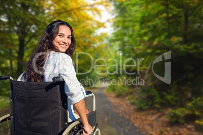 Young woman in wheelchair on street