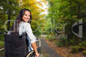 Young woman in wheelchair on street