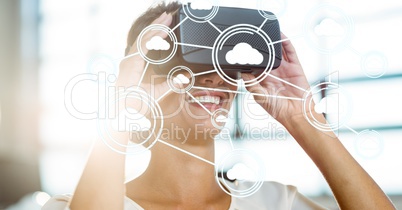 Digitally generated image of cloud computing icons with woman using VR glasses in office