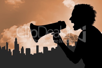 Silhouette woman screaming in megaphone against buildings and sky