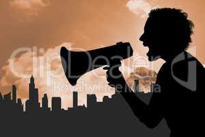 Silhouette woman screaming in megaphone against buildings and sky
