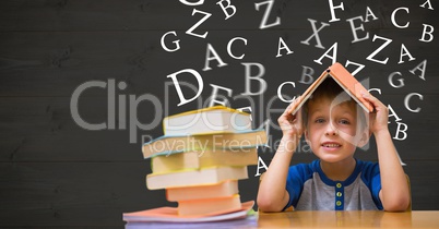 Boy with book on head against letters flying in background