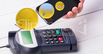 Emojis flying over mobile phone during NFC payment