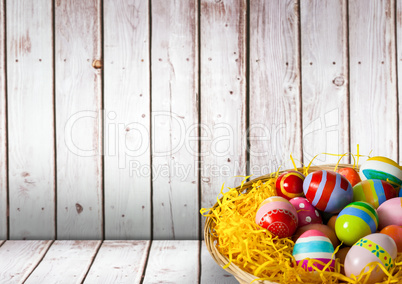 Basket with Easter eggs with wood background