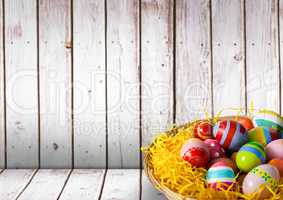 Basket with Easter eggs with wood background