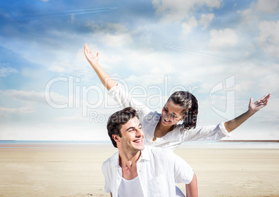 Happy couple laughing in the beach.