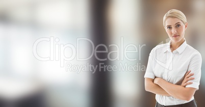 Serious business woman with her hands folded on blurred background