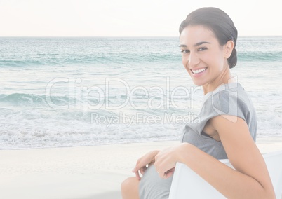 Smiling woman sitting by sea