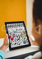 Kid at desk holding tablet showing music doodles on sketchbook