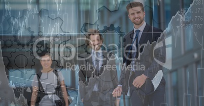 Three business people with chart and gear graphic overlay