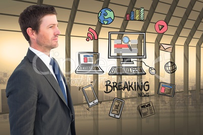 Businessman looking at various icons surrounding computer and breaking news
