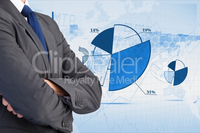 Digitally generated image of businessman with various charts in background