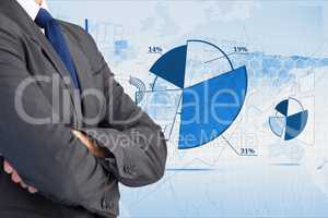 Digitally generated image of businessman with various charts in background