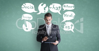Businessman  using tablet computer with speech bubble against green background