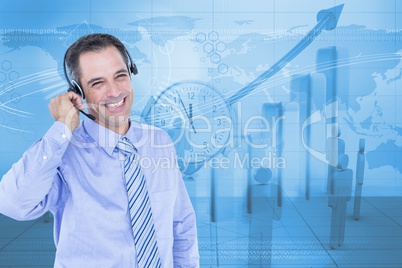 Digitally generated image of businessman using headphones with employees and graph in background