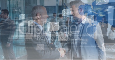 Digital composite image of business people shaking hands with message icons and binary code on scree