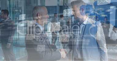 Digital composite image of business people shaking hands with message icons and binary code on scree