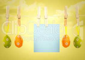 Blue note on washing line with eggs against yellow sky