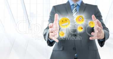 Business man mid section with emojis and flares between hands against white window