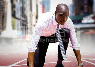 Business man at start line against blurry city