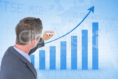 Digital composite image of businessman analyzing bar graph