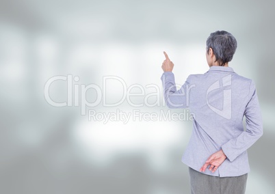 Businesswoman touching air against bright background