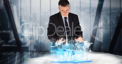 Digital composite image of businessman working on project at desk