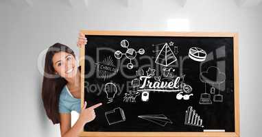 Portrait of happy woman showing travel icons on blackboard