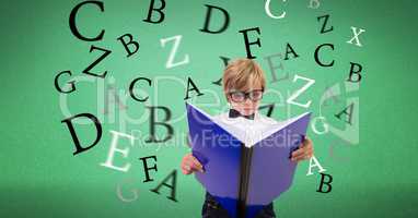 Boy reading book with letters flying in background