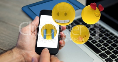 Hands using emojis on smart phone