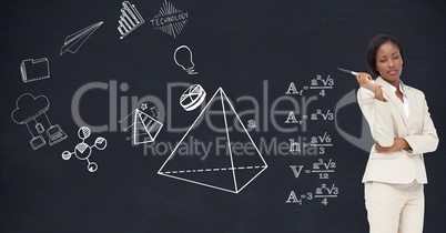 Businessswoman standing against blackboard with various formulas and icons