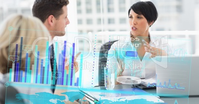 Digital composite image of business people in meeting with graph on screen on foreground