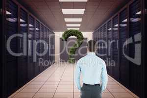 Rear view of businessman looking at question mark