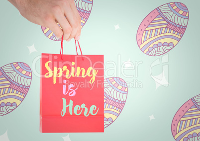 Hand holding red bag with with type against blue easter pattern